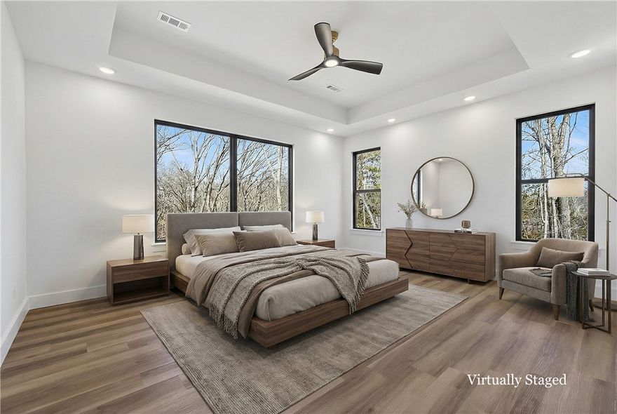 Look no further, this beautiful new construction home is perfectly situated in the heart of Bella Vista! Located in the Bentonville School District and just 15 minutes from the new Walmart Home Office, this home backs up directly to the Tunnel Vision Bike Trail, offering unmatched access to Bella Vista's renowned trail system right from your backyard. Inside, you'll find 10-foot ceilings, custom cabinetry, granite countertops, large windows, luxury vinyl plank flooring, and stylish modern finishes throughout. The open split floor plan is designed for functional everyday living, featuring a spacious primary suite and walk-in closets. The outdoor deck overlooks a wooded setting, ideal for nature lovers and those seeking privacy all while being close to daily conveniences.