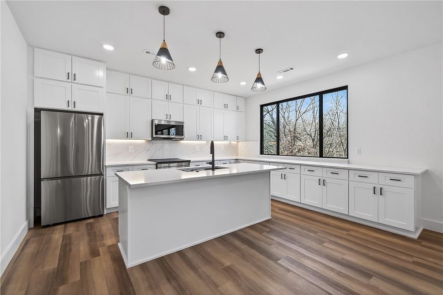 Look no further, this beautiful new construction home is perfectly situated in the heart of Bella Vista! Located in the Bentonville School District and just 15 minutes from the new Walmart Home Office, this home backs up directly to the Tunnel Vision Bike Trail, offering unmatched access to Bella Vista's renowned trail system right from your backyard. Inside, you'll find 10-foot ceilings, custom cabinetry, granite countertops, large windows, luxury vinyl plank flooring, and stylish modern finishes throughout. The open split floor plan is designed for functional everyday living, featuring a spacious primary suite and walk-in closets. The outdoor deck overlooks a wooded setting, ideal for nature lovers and those seeking privacy all while being close to daily conveniences.