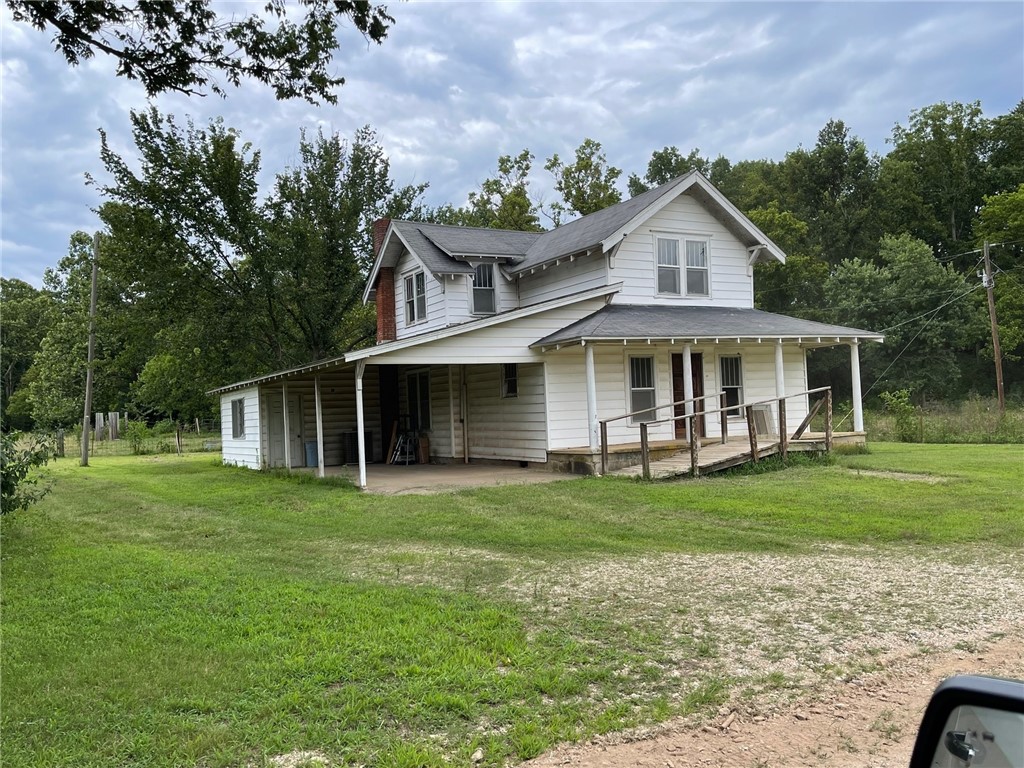 Large home situated on 3 acres m/l out in the country. This home has unlimited potential with a little tlc. The house offers hardwood floors and a master bedroom on the lower level. The upper level has 1 bedroom and 2 other rooms that could be used as bedrooms. With a few acres available this property could also be used as a mini farm. Located just a short distance from a paved road and it has public water on site. Located close to Table Rock Lake and Branson MO.