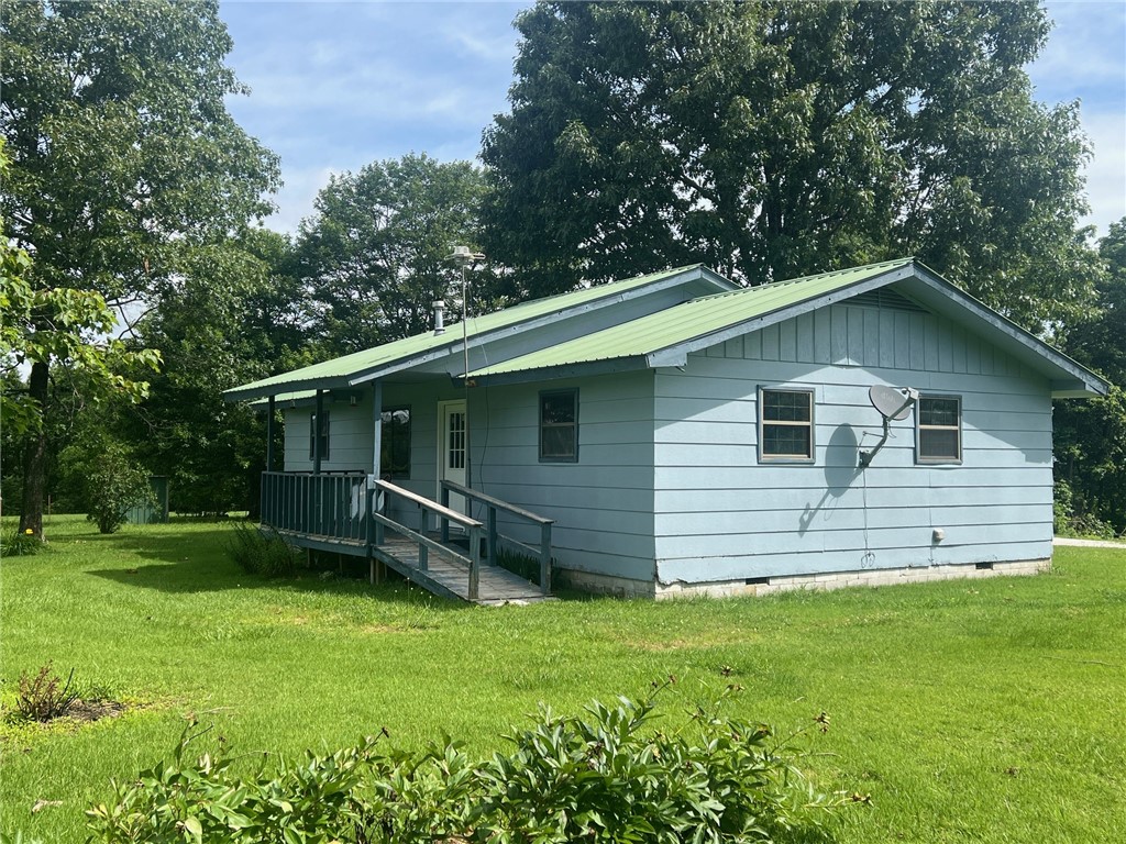 2 Bed/ 2 Bath farmhouse on 6 leveled beautiful acres full of mature fruit trees, flowers, hardwoods, and area for large gardens. Home has had renovations started but is sold as is. Tons of potential to make this your own with an open floor plan with two masters. 4 stall pole barn to store all of your equipment and easy access off of Hwy 16, but far enough back to feel private and quiet. Enjoy this area of Newton county, close enough to Jasper and peaceful surroundings.