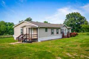 Very nice completely remodeled double wide on 1.5 acres fenced and cross fenced. Upgrades include new flooring, carpet, paint throughout, refrigerator, dishwasher, hot water tank and a very nice covered deck on back. There are fruit trees plus a garden area. Fruit Trees, 3 apple, 2 peach, 1ea plum, pear, and apricot. This one is well cared for and move in ready. Located within 10 miles of Green Forest or Harrison. Would make a great starter home.
