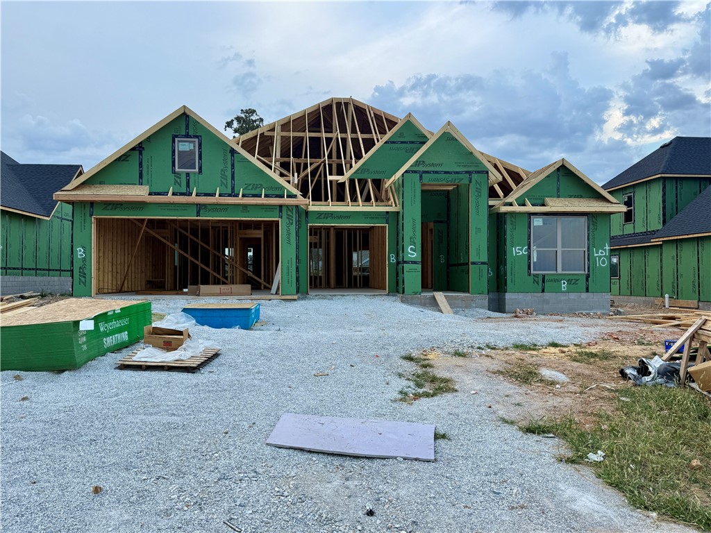 Hillcrest in Cave Springs offers the perfect blend of peace and convenience—set on the edge of town for a quiet retreat, yet only minutes from everything Northwest Arkansas has to offer. This beautiful new construction offers 3 bedrooms, 2 baths, and 2,184 sq ft of thoughtfully designed living space. Situated on a .19-acre lot in the desirable Hillcrest Subdivision within the Rogers School District, you’ll enjoy a peaceful setting just minutes from all that Northwest Arkansas has to offer. The open-concept layout features wood flooring, abundant natural light, and a cozy fireplace in the family room. The kitchen is equipped with a gas cooktop, quartz countertops, and a spacious pantry. The primary suite offers a soaking tub, walk-in shower, and large walk-in closet. Two additional bedrooms and a full bath provide plenty of space for family or guests. Additional highlights include a 2-car attached garage, covered back patio, and fenced backyard.