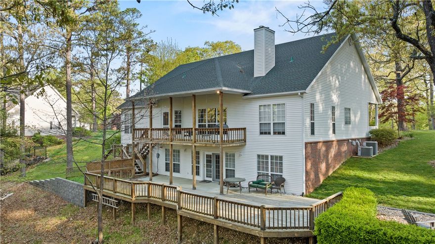 Located in the dreamy Runnymede Beaver Lake community near downtown Rogers, 14 Ravenshoe is an expansive home set in a peaceful, park-like setting with a private two story deck and includes a 10'x24' boat slip in a co-owned dock. Incredibly, this property is offered fully furnished. Enjoy the large recreation room, wet bar, and workshop in the walkout basement. The formal dining room and double ovens are ready to host large gatherings of friends and family. Runnymede offers residents a private beach & nature trail; take in all the views while riding a golf cart or side-by-side. Order-in using grocery delivery provided by Walmart. After a full day of boating, be sure to unwind in the forested backyard next to your fire pit. Use as a short term rental is allowed. Schedule your private showing today.