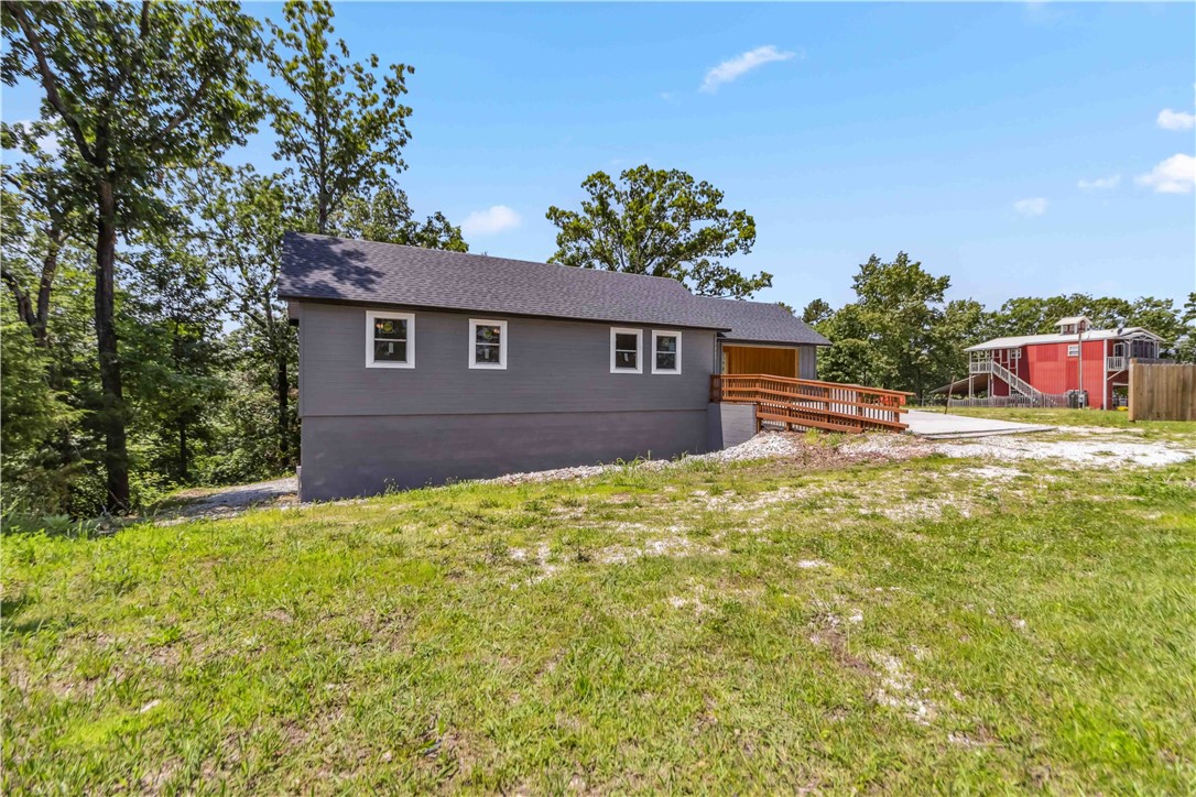 Modern new construction home on Highway 12 near Beaver Lake. The main level features one bedroom, one full bath, a bonus room, and an open kitchen with brand-new appliances. The finished basement includes a half bath and separate entrance, offering flexible space for a game room, gym, or media room. The large gravel lot provides ample space for boats, RVs, or other recreational gear. Just 2 miles from the Highway 12 public boat launch, 5 miles from Prairie Creek Marina, and 13 miles from Hobbs State Park. Great potential as a short-term rental or weekend getaway with quick access to boating, hiking, and lake recreation.