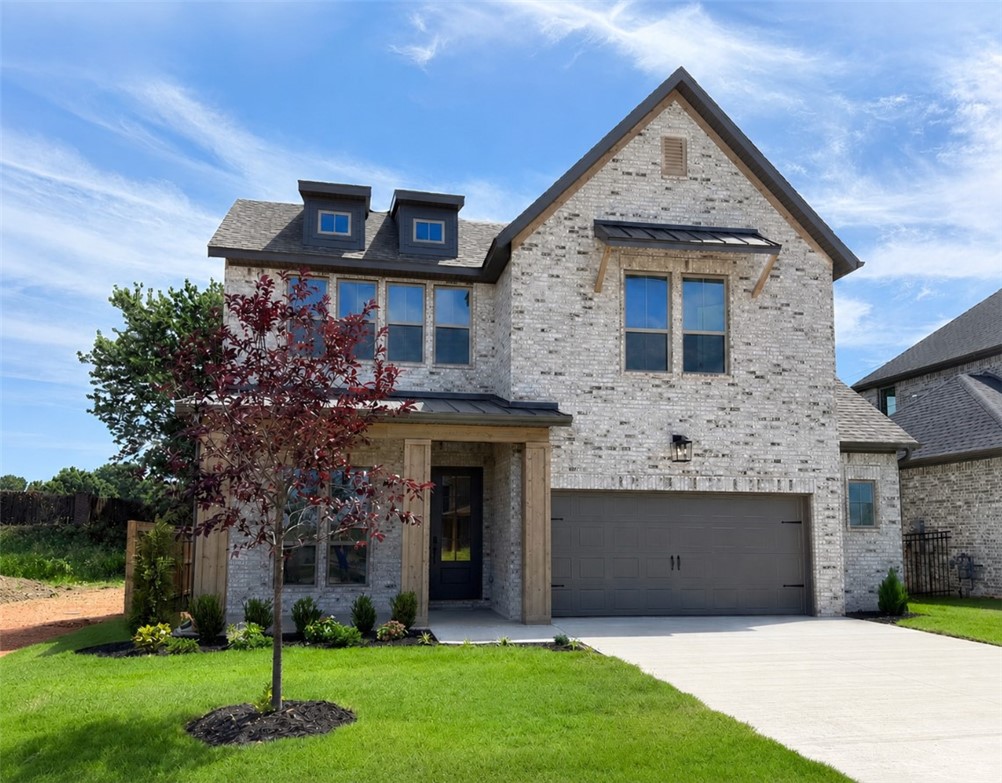 Two-story brick exterior featuring a multi-gable r