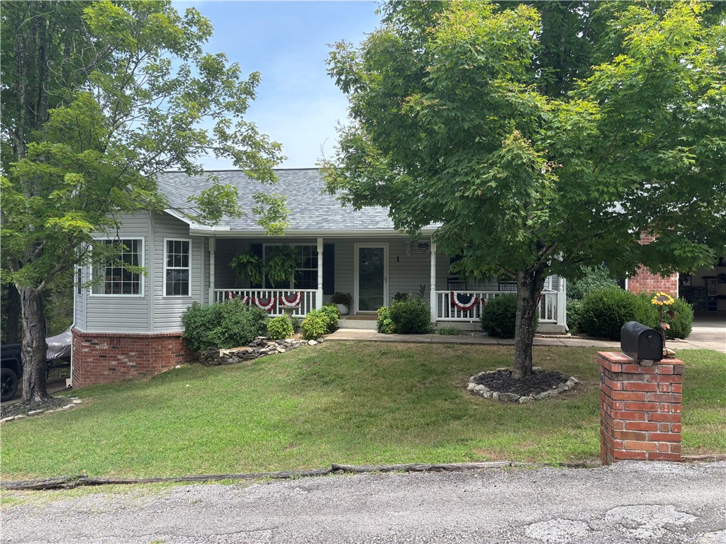 This beautifully updated and maintained 3-bedroom, 2 ½ -bath lake area home features recent upgrades including a new roof, gutters, and downspouts (2023), high-efficiency propane furnace (2019), and new water heater (2024). The primary bedrm closet is lined with cedar, with a handmade built in cedar dresser & drawers. The property boasts exceptional workspace with a detached two-car garage (60-amp electrical), attached two-car garage (20-amp electrical with utility sink), bonus hobby room equipped with 20-amp electrical, water softener and in-house generator plug-in. Also boasts a new 6' privacy fence. Included appliances: refrigerator, hot tub, washer and dryer. Located minutes from Table Rock Lake and White River for fishing, boating, swimming. Community amenities include two golf courses, clubhouse, outdoor pool, and recreation center. Conveniently positioned 45 minutes from both Rogers, AR and Branson, MO, offering the perfect blend of peaceful lake life and easy access to city conveniences.