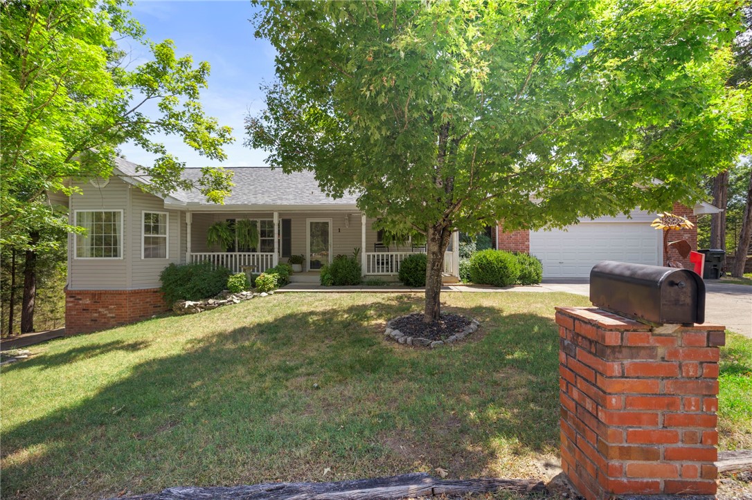 This beautifully updated and maintained 3-bedroom, 2 ½ -bath lake area home features recent upgrades including a new roof, gutters, and downspouts (2023), high-efficiency propane furnace (2019), and new water heater (2024). The primary bedrm closet is lined with cedar, with a handmade built in cedar dresser & drawers. The property boasts exceptional workspace with a detached two-car garage (60-amp electrical), attached two-car garage (20-amp electrical with utility sink), bonus hobby room equipped with 20-amp electrical, water softener and in-house generator plug-in. Also boasts a new 6' privacy fence. Included appliances: refrigerator, hot tub, washer and dryer. Located minutes from Table Rock Lake and White River for fishing, boating, swimming. Community amenities include two golf courses, clubhouse, outdoor pool, and recreation center. Conveniently positioned 45 minutes from both Rogers, AR and Branson, MO, offering the perfect blend of peaceful lake life and easy access to city conveniences.