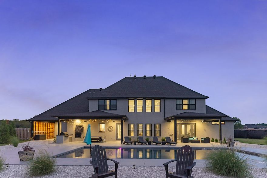 A Contemporary Masterpiece! Custom-built in 2018, featuring 4884 Sqft, 5-6 bedrooms, 4.5 baths, Media room, Pool, 1100 sqft boat-depth Garage and over 500sqft of outdoor covered entertaining space!.  Stunning 22 foot ceilings in great room, with leathered-concrete fireplace as the focal point.  A chef's kitchen with marble countertops/backsplash, professional series appliances.  Master suite is over 1,000 feet of luxury with huge walk in closet. Craft-room/office with built-ins,   Cable rail system for stairs and balcony.  10 speaker Bluetooth speakers wired for easy access for entertaining.   Outdoor area  features built in grill area, Wired for tv and outdoor fireplace, Leathered granite bar top.  Professionally landscaped 1.4acres.  16x40 custom gunite pool with Riverrock 25 year coating.  Salt water, heated with LED lights.   An Entertainers dream home!