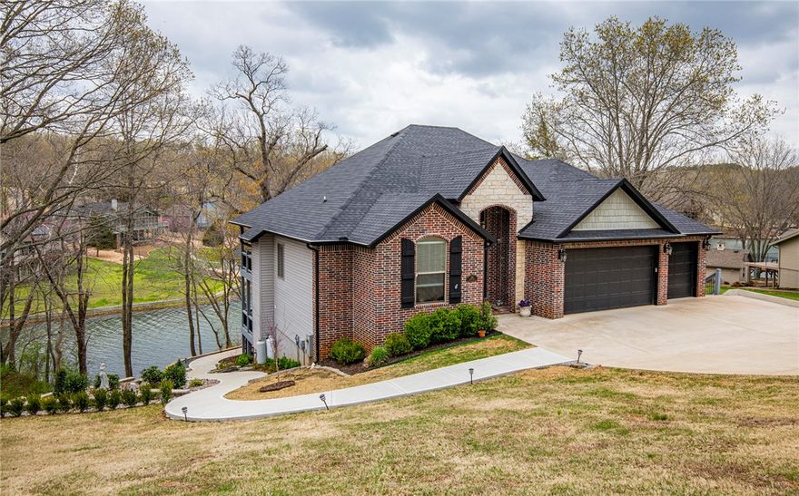 Stunning newer construction Loch Lomond lake front home with gentle sloped concrete walk to your private boat dock! Lake views throughout the 4 bedrooms, 3 full bathrooms, large office, open spacious floor plan with 2 large living areas and a gas fireplace. Gorgeous kitchen has double islands and double sinks with huge pantry. Grand master with pretty on suite and large walk in closet. Beautifully landscaped with 2 large covered decks and a stamped patio, all with outstanding lake views!