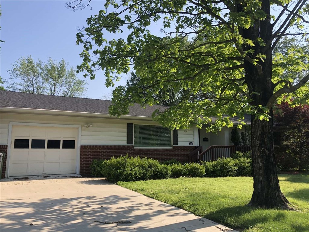 This updated ranch-style house near downtown Rogers is perfect for young professionals, small families, retired couples, or single buyers. Key features include original hardwood floors, a remodeled kitchen and bathroom, and a spacious backyard with a fire ring and deck. The backyard has a new privacy fence, with gates on either side of the house. New appliances, granite countertops, spacious custom cabinetry, upgraded lighting, and a kitchen island will entice home cooks and entertainers. The attached 1-car garage offers a work bench, shelving for storage. Both bedrooms have spacious closets with built-in shelving. The newly renovated bathroom has a luxurious walk-in shower. The open-concept living room and kitchen/dining area are full of natural light from large windows. Small walk-in pantry, built-in office nook, and bookshelf add character and functionality. A brand new extension of the greenway path is accessible at the end of the block, connecting you with the regionās network of walking and biking trails.