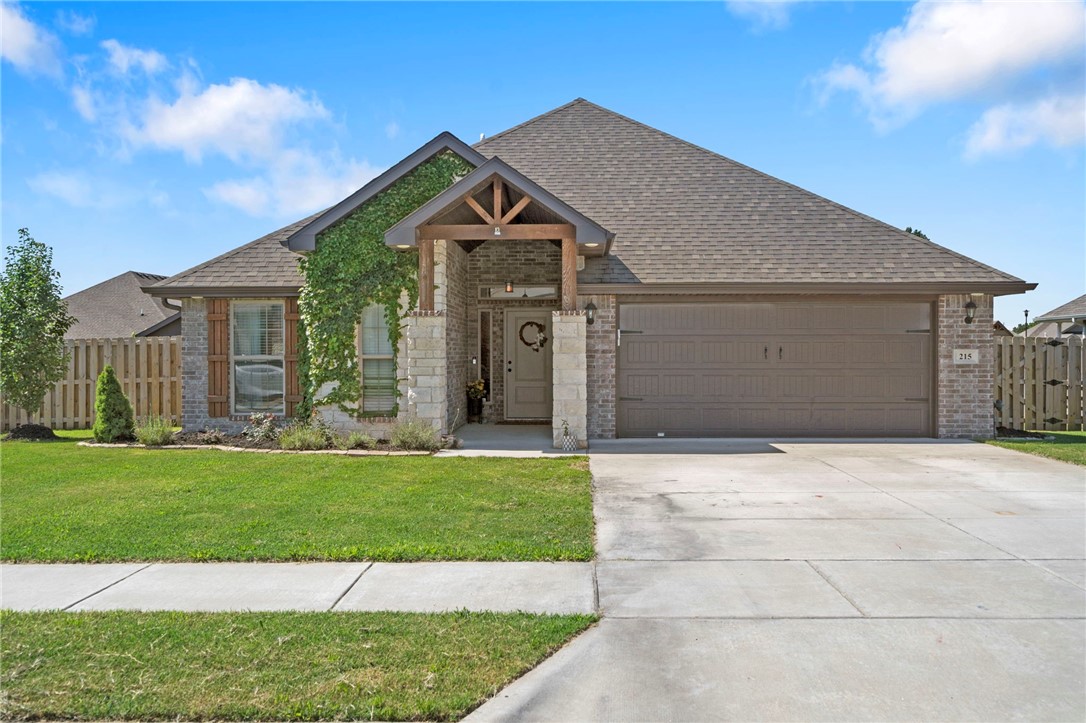 Welcome to 215 Hunt Street in the heart of Pea Ridge—where comfort, style, and convenience come together in a growing, family-friendly community. Built in 2021, this 4-bedroom, 2-bath home offers 2,013 square feet of thoughtfully designed living space with a split floorplan ideal for families or guests. Enjoy wood-look tile in the main living areas, a spacious eat-in kitchen with granite countertops, and an oversized electric fireplace perfect for cozy nights in. Curb appeal shines with a charming entryway featuring warm wood accents and stone pillars, while the large, partially covered back patio provides the perfect setting for outdoor entertaining. Just 15 minutes from Walmart’s new Home Office and the Bentonville Square, 20 minutes from the Walmart AMP, and close to Big Sugar Golf Club, this home offers small-town charm with big-city access. Don’t miss your chance to be part of a vibrant, fast-growing Northwest Arkansas community!