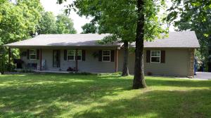 Like new! This 3 bed, 2 bath home has been well maintained, has an open floor plan, new stainless appliances,new HVAC, hardwood flooring, two car garage, deck, full length covered porch, paved driveway, and a park like setting on 3.5 acres where wildlife abound only minutes from town in Bergman school district.