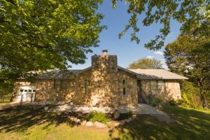 Don't miss this opportunity! Beautiful stone facade home with frontage on Clear Creek! Very well maintained one owner home in Everton on a private setting with pretty views of the hills and creek. Updated interior paint and floor coverings. Home features 3 beds, 3 baths, nearly 3000 sq ft, built in shelving, fenced yard, and a GORGEOUS stone fireplace in the great room. Basement has a large family/ entertaining room with wet bar, the 3rd bedroom, 3rd bath, and 2nd garage with workshop area.