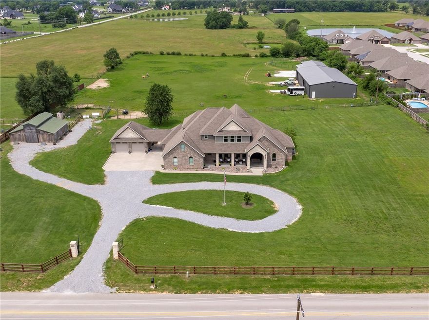 Rare find!  Amazing custom-built home on 5 acres with 5000 sft. shop building, 1260 sft. four-stall horse barn, fully fenced and cross-fenced pasture. Plus a charming refurbished barn with reclaimed wood! This gated residence captivates the essence of country with city convenience in amazing location. Inviting entry with open concept and expansive picture windows from every room. Thoughtfully designed 4BRS, 3 full baths plus bonus room, and 4 car garage.  Stunning interior features include designer lighting, custom cabinetry, brick accents walls.  Gourmet kitchen boasts granite, center island, SS appliances with double ovens, and office alcove. Main level master with patio access and spa like bath. Second level features additional BR and bonus or living area. Covered front and back porches offer gorgeous pastural views.  Shop and barn are constructed with red-iron steel and feature overhead doors.  See attachments for detailed information on barns, outbuilding and property upgrades.