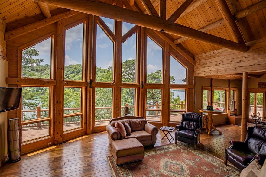 Beaver LAKEFRONT Log Cabin Paradise w/Emerald Green LAKEVIEWS in Quiet Cove, & an easy walk to your Boat SLIP in Community Dock. This Rustic, Custom Built, one-owner Log Home on 1.15 acres boasts Soaring Log-beamed Ceilings and Wall of Windows showcasing Gorgeous Lakeviews, from every Room. Main level offers an Open Layout- Great Room w/Gas Stone Fireplace, Spacious Eat-in Kitchen with Large island, 2 Sink Stations, Built-in Oven/Microwave combo and whole house generator. In addition to 3 Bedrooms w/Walk-in Closets, each with own Private Bath, and Direct Exterior Access, the Oversized Loft Space w/Never-ending Views allows for versatile options of use. Walkout Basement features second Living Area, 2 of the Bedrooms, Utility room w/fridge & utility sink, and under house Storage. This Wooded and Private Retreat has it All.  List of improvements attached. Live the Dream Vacation Everyday at Home!