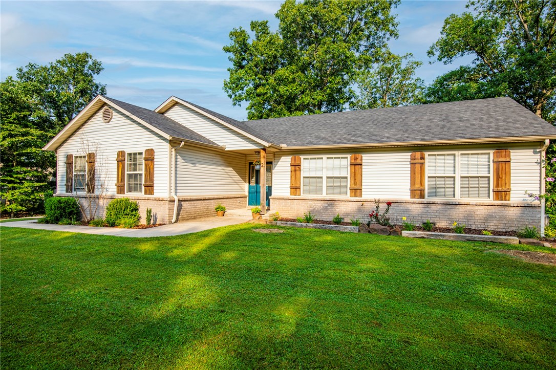 Known for its natural beauty, the town of Bella Vista is where to find this gorgeous house on a beautiful oversized corner lot on a quiet and peaceful street. This 3 bedroom 2 full bath home welcomes you with vaulted ceilings and natural light in the LR-kitchen area with a nice open floor plan and a wood burning fireplace. The master welcomes you with tray a ceiling and flows into the master bathroom. This home is move-in ready, super clean and well taken care of. The fenced backyard provides an outdoor setting during all four seasons with a relaxing covered deck to enjoy and hang out with family and friends. well established neighborhood that offers a peaceful and quiet setting with nature. Located minutes west of I49, close to Wal-mart and other amnesties as well! This gem is close to schools, grocery, medical facilities, and more.