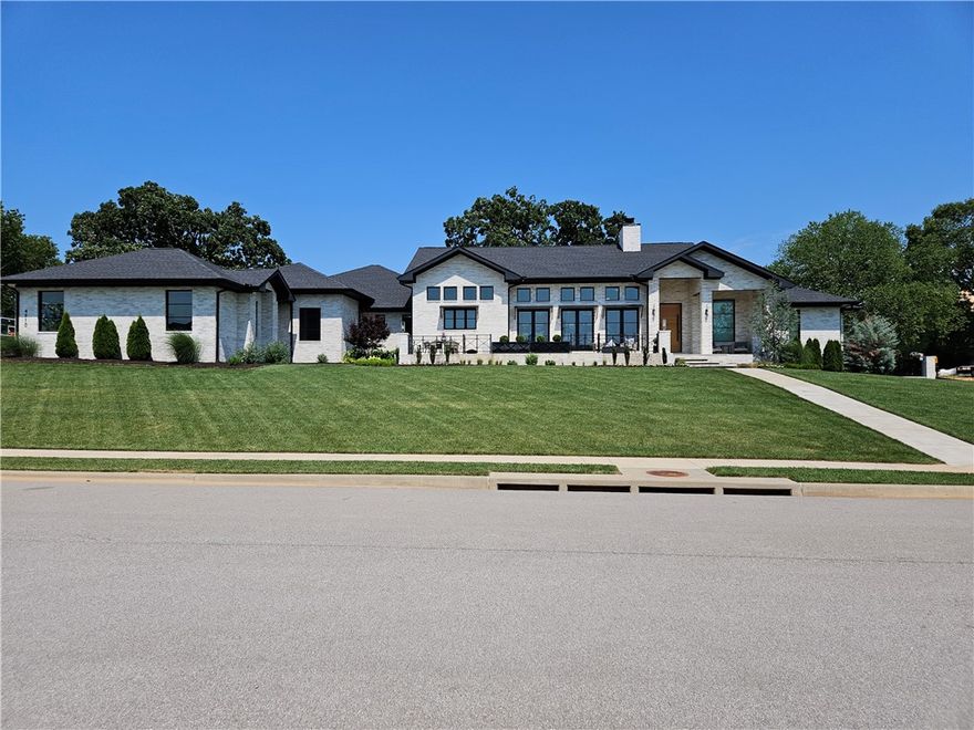 Gorgeous one level home in sought after Estates at Southgate in Rogers. Home features split floorplan, 4 bedrooms, game room with mini fridge and serving window to covered patio, 3 full baths, 2 half baths, 4 car garage, F5 tornado shelter inside glass walled office, automatic window shades, new AV, security system, sprinkler system, vaulted ceiling complete with wood beams in living area and master bedroom. Kitchen has a large island, 2 wine fridges, double oven, & large butlers pantry. Master bedroom features high ceilings, fireplace, coffee area with mini fridge, large walk in shower, separate tub, stackable W/D, his/her closets & water closets. The home is set up perfectly for entertaining with French doors opening to front patio where you can relax & watch sunset bedside outdoor fire pit, and sliding glass doors on back that lead to pool area, multiple sitting areas, complete with outdoor kitchen, 2nd fire pit, eating areas, & large yard with separate fenced in area. To much more to list, this wont last long.