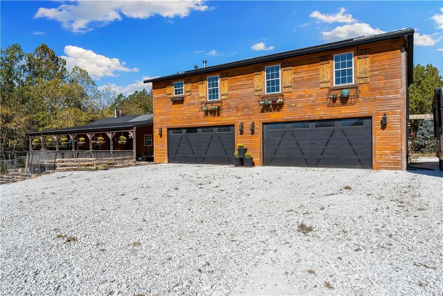 This 6-bed 4-bath home features an in-ground pool & a 1,500 sqft outdoor kitchen, complete with a full bathroom, seating bar, hot tub, & all the space you need for gatherings of any size. Adventure awaits with a 400 sqft treehouse, axe-throwing range & open areas perfect for any hobby. For added peace of mind, the property backs to the Mark Twain National Forest, offering privacy & stunning natural surroundings. Inside you will find spacious living areas, a fully finished walkout basement & upper-level second living room/game room, providing room for everyone to relax and enjoy. The home also features a tankless water heater, solar panels, & two high-efficiency dual-fuel HVAC systems, ensuring year-round comfort & energy savings. Car enthusiasts & hobbyists will appreciate the 4-car garage with abundant storage. Just a short drive to Beaver Lake & close to Rogers, Bentonville, & Pea Ridge. With its exceptional amenities, thoughtful upgrades, this home delivers the ultimate in luxury country living.