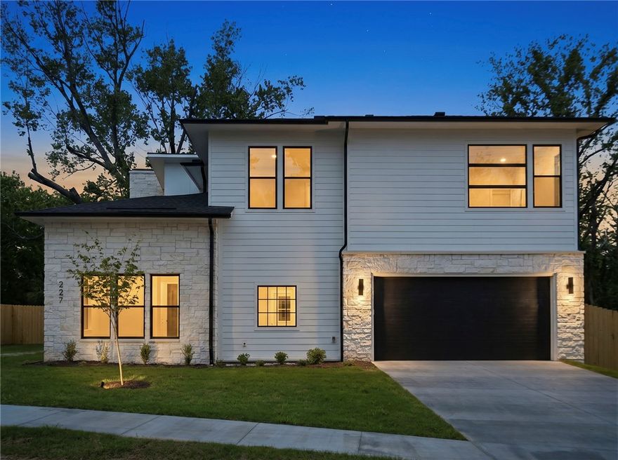 Downtown beauty! This brand-new custom home, moments from the Bentonville square, delivers 3,946 square feet of thoughtful luxury on a 0.22-acre lot. The floor plan offers five bedrooms and 5.5 baths, including a private primary wing and four additional en-suite bedrooms. The kitchen is a standout—fitted with a full Monogram appliance suite, a professional gas range with champagne gold accents, and a striking vent hood. Frosted-glass cabinetry, pull-out spice racks, and a butler’s pantry add both style and function. The living area centers around a sleek linear fireplace set into a vertical tile feature wall with a rustic timber mantel. The gorgeous primary suite includes a stunning bath, complete with a large glass shower and freestanding tub. The mudroom, bonus room with wet bar, designer lighting, and modern tech throughout balances luxury and everyday living. Location is everything with easy access to the Walmart campus, Crystal Bridges, Bentonville parks and trails, and I49.