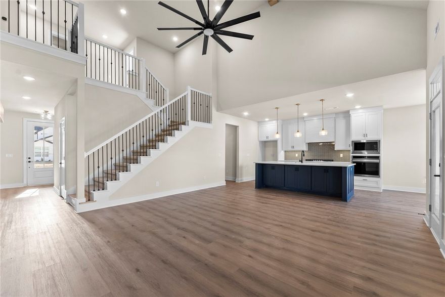 Seller offering $10,000 in concessions! 4 Bedrooms + Bonus + Office! This beautifully upgraded home offers incredible value with plenty of space to spread out. The open-concept main level is anchored by an oversized island & features quartz countertops, custom ceiling-height cabinets, a walk-in pantry, & luxury vinyl plank flooring throughout. The first floor includes two bedrooms, two full baths, & a cozy office. Upstairs you’ll find two additional bedrooms, a full bath, & a large theater/game room perfect for entertaining or relaxing. Thoughtful upgrades include tiled showers, an electric fireplace with custom trim, an EV charging port, & a gas line ready for outdoor grilling. Just minutes from Bentonville Schools, I-49, downtown Bentonville, & Walmart.