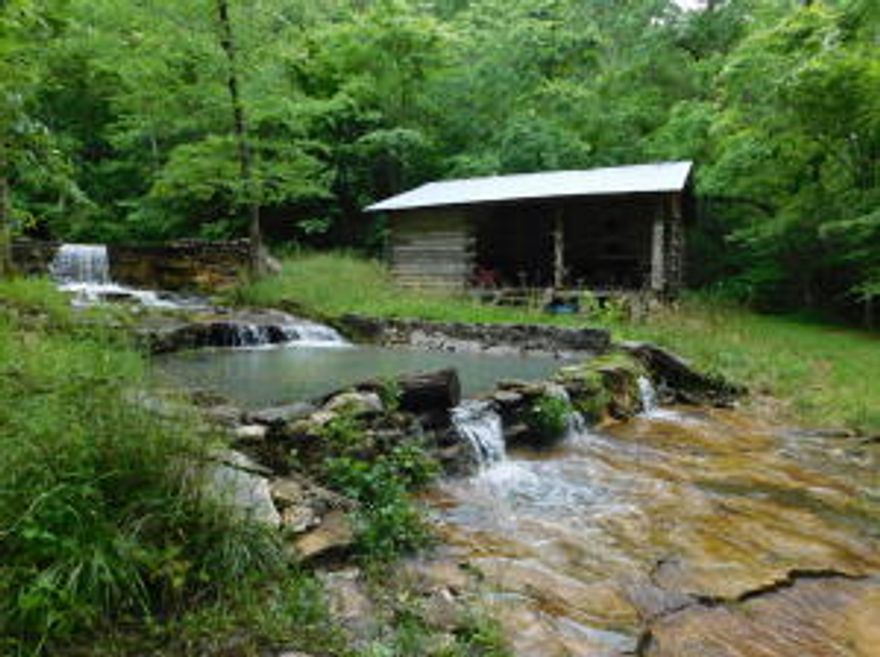 This unique Ozark Mountain Region hunting/recreational land consists of 850 +acres bordering the Buffalo National River Park land. Awesome views of the surrounding mountains. The real estate includes a home, a cabin with electricity and water, a cave (named Big Bear Cave), and one of a kind large spring with a waterfall. The acreage features rolling terrain of timber, native grass, several ponds and creeks that run through the property. It was previously used as a hunting club with cabin rentals.This property is extremely dynamic, offering great interest to both hunting and recreational enthusiasts because of the healthy populations of whitetail deer, turkey small game and trails for ATV or horseback riding.