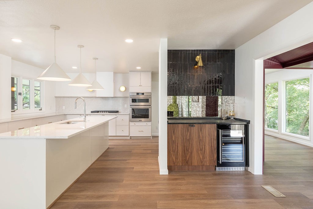 Beautifully renovated mid-century home sitting on top of Mount Sequoyah with treehouse views on a flat, walkable street.
The design of this home has been completely re-engineered to optimize flow and function. It features an expansive kitchen with an adjacent beverage bar and soapstone countertop. The sunroom is a great dining area located just off of the kitchen.
There are two large living room spaces each featuring fireplaces. The rooms are flooded with natural light and scenic views.
The new primary bathroom is spacious with designer finishes and the powder bath features a hand carved marble sink from Turkey.
Enjoy secluded backyard views from two decks or sit by a fire pit under more than 100 string lights.
The front of house offers outdoor seating and community as the street is mostly accessed by walkers and bikers. It is a downhill walk to Root Elementary with close access to the University and the downtown historical district.
Welcome to a great location in the heart of Mt. Sequoyah!