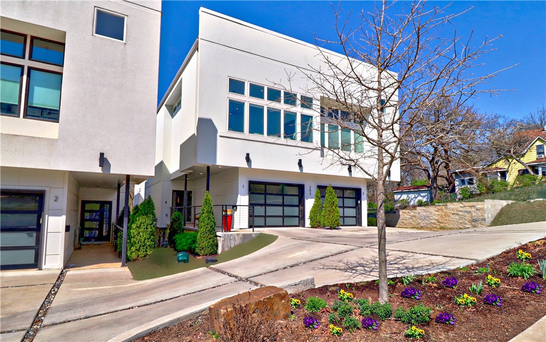 Spectacular home in fabulous downtown! Close to E. Fay Jones Park, community trails & the Ramble. The bright interior is set off with the lg windows that welcome the views of outdoors. Contemporary, vibrant feel w/sleek finishes that accentuate the interior. The spacious living area is open & welcoming w/soaring ceilings, cozy electric/lighted fireplace, well designed kitchen & lovely dining area. The windows have remote control blinds that offer privacy and convenience. Top-of-the-line kitchen appliances enhance the kitchen & there is a large island that is perfect for everyday living, cozy gatherings or dinner parties. The upper level features a wonderful rooftop patio with outdoor kitchen, heater in covered area & great views. Sit & enjoy the magnificent sunsets. Owner’s ste has great views w/large windows & an upscale bathroom w/walk-in shower w/dual body sprays, rain shower heads & Toto commode. Owner’s closet has 3 built chests of drawers. 2-car tandem garage. Easy walk to Theatre Squared, WAC, & Dickson St.