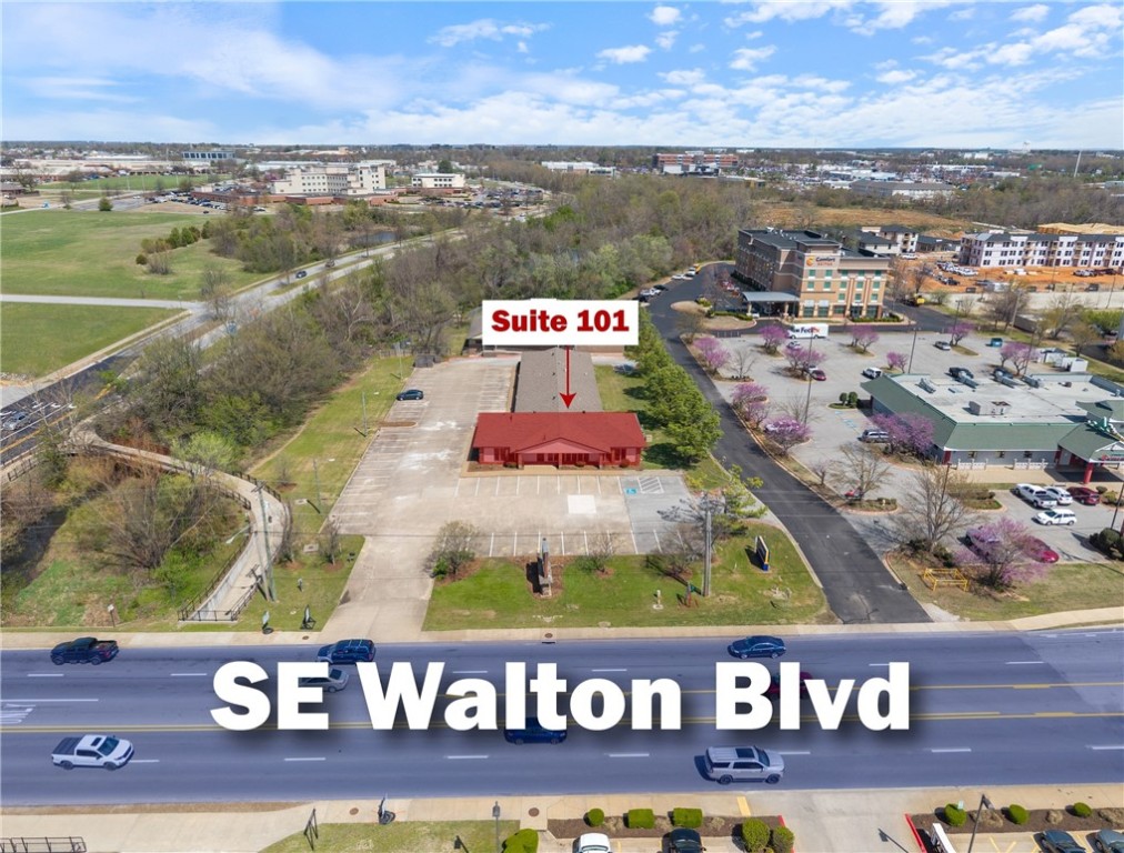 +/- 3,150 SF prime office or medical office space ideally located just off SE Walton Blvd, a high-traffic corridor with approx. 38,000 VPD. This well-designed suite, situated at the rear of the building, offers a functional layout that includes a welcoming reception area, a kitchen, 5 private offices, a conference room or open workspace, and a private restroom. Positioned at the busy intersection of SE Walton Blvd and Medical Center Parkway, this property provides excellent accessibility and visibility. It is also less than half a mile from I-49, the primary interstate system that runs through Northwest Arkansas, which sees an average of 101,000 VPD. Additionally, Walmart's new 350-acre World HQ is just 2.5 miles away, and XNA is conveniently located about 20 minutes away, making this an ideal location for businesses seeking connectivity and growth opportunities.