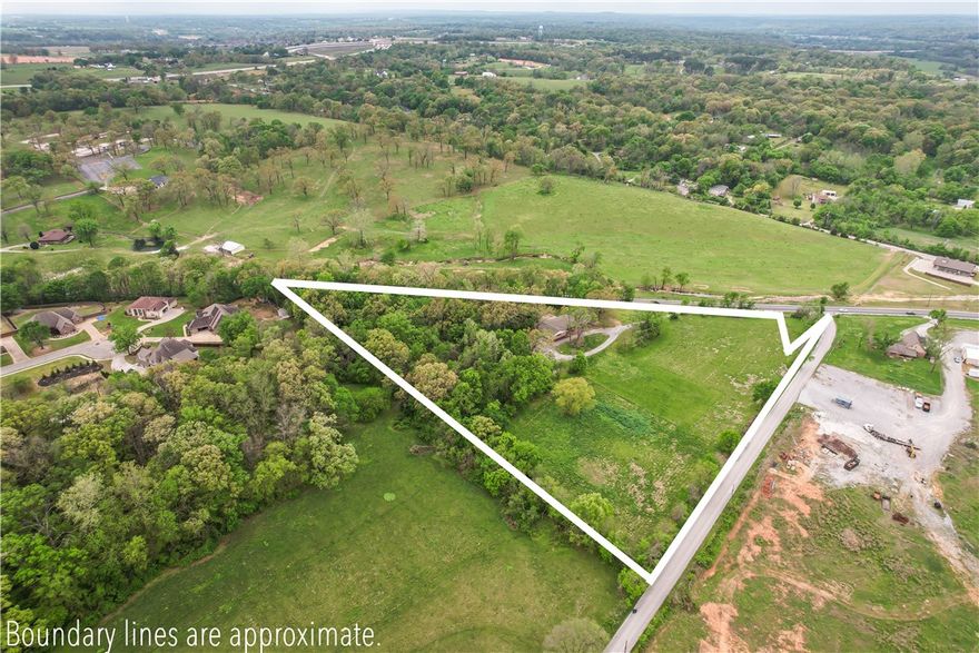At the heart of it all! Minutes from XNA Airport, I-49, Hebron & Shaw Parks, and Walmart Arkansas Music Pavilion (The AMP). Located across from a major planned development. Buyer to verify zoning, planning, and development potential with the City of Springdale and Benton County. Value is in the land. Highway 112 is planned for expansion into a divided four-lane highway from Springdale to Bentonville, with the Highway 612 bypass currently expanding from Hwy 112. Close to parks, trails, and recreation supporting Northwest Arkansas’ quality of life. Existing home included, as is. Showings by appointment only with verified financials. Proof of funds or lender pre-approval required. County records states 7.88 acres although a current survey indicates 7.08 acres. Arkansas Highway 112 is currently undergoing a widening project. As a result, the exact land measurements may vary between county records and the most recent surveys.