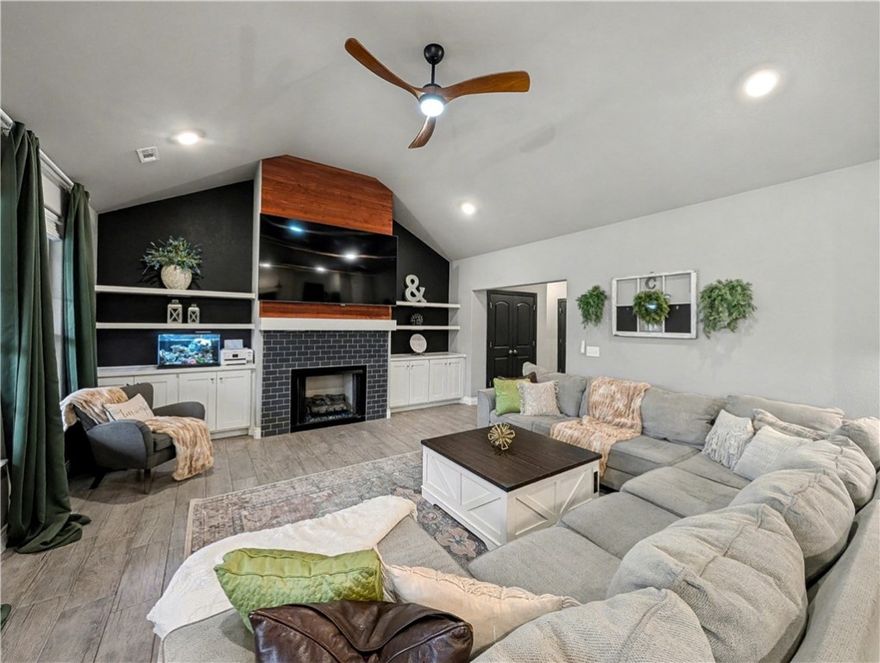 Welcome To Your Next Home—And She’s An Absolute Vibe! This North-Facing, Full-Brick Stunner Isn't Just A House, It's A Lifestyle Upgrade. Step Inside And Get Ready To Swoon: The Living Room Is A Sun-Drenched Showstopper With Soaring Vaulted Ceilings And A Gorgeous Statement Fireplace Framed By Custom Built-Ins. That Sleek Wood-Look Tile Flows Everywhere, Leading You To A Kitchen That Will Have You Hosting Everything. We're Talking Custom Cabinets, Upgraded Granite, Gas Range With A Custom Hood, Big Pantry, And A Massive Island With Bar Seating That’s Just Begging For A Party. Eat-in Dining. Split Floorplan Tucks Your Primary Suite Away—Featuring Dual Vanities, Tile Shower, Soaker Tub, And A Walk-In Closet. On The Other Side Of The House, Three More Spacious Bedrooms And A Full Bath Give Everyone Their Own Space. Covered Front Porch And Back Patio w/ Gas Grill And TV Connections. The Fully Fenced Yard. Bentonville Schools - Gamble Elementary Across The Street And Bentonville West Just A Short Walk. This Is The One.