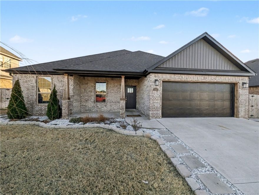 Welcome To Your Next Home—And She’s An Absolute Vibe! This North-Facing, Full-Brick Stunner Isn't Just A House, It's A Lifestyle Upgrade. Step Inside And Get Ready To Swoon: The Living Room Is A Sun-Drenched Showstopper With Soaring Vaulted Ceilings And A Gorgeous Statement Fireplace Framed By Custom Built-Ins. That Sleek Wood-Look Tile Flows Everywhere, Leading You To A Kitchen That Will Have You Hosting Everything. We're Talking Custom Cabinets, Upgraded Granite, Gas Range With A Custom Hood, Big Pantry, And A Massive Island With Bar Seating That’s Just Begging For A Party. Eat-in Dining. Split Floorplan Tucks Your Primary Suite Away—Featuring Dual Vanities, Tile Shower, Soaker Tub, And A Walk-In Closet. On The Other Side Of The House, Three More Spacious Bedrooms And A Full Bath Give Everyone Their Own Space. Covered Front Porch And Back Patio w/ Gas Grill And TV Connections. The Fully Fenced Yard. Bentonville Schools - Gamble Elementary Across The Street And Bentonville West Just A Short Walk. This Is The One.