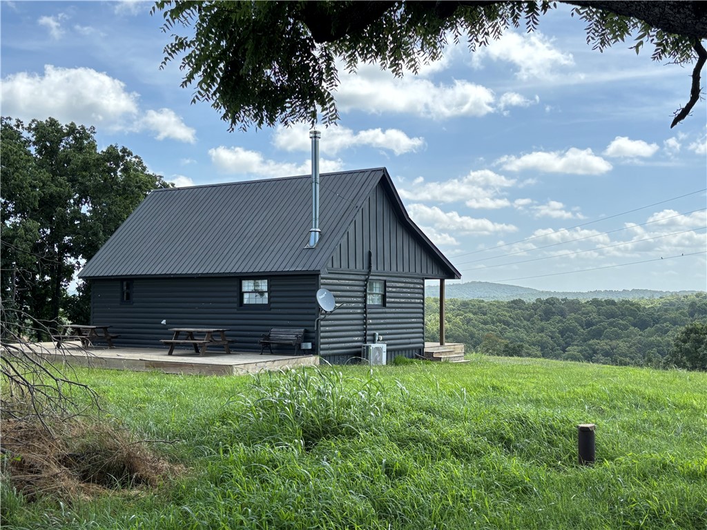 Experience Ozark Mountain scenery in all directions from this hard to find 215 acre property! Enjoy rolling, useable landscape with 25 acres open/190 acres wooded m/l, county road frontage, 3 ponds, and 2 drilled wells. Take in the long views from the deck areas of the nicely finished 960 sqft cabin with large sleeping loft, full bath, mini-split heat/AC, and cozy wood stove. Newly updated 32x44 metal, insulated, wired shop with lean-to provides a perfect place for projects or storage. Other outbuildings include 40x60 shop building, 24x40 building, 48x58 barn. Lots of value and numerous options to suit your needs. Great property with room to roam and enjoy the outdoors, suitable for your weekend getaway or build your primary residence. Peaceful, country setting with ease of access to all the necessities. Water, electric/fiber optic, and a lake area location. So many features and possibilities in this gem of a property!