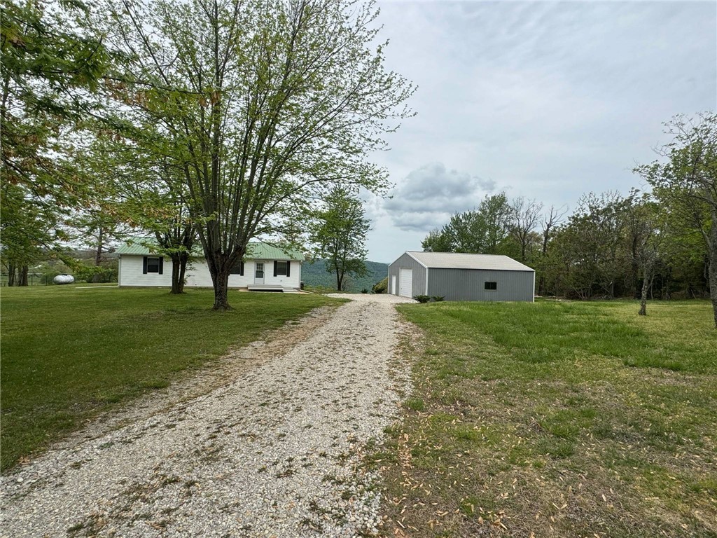 Spectacular Ozark valley views and a prime location near Scenic point, minutes to the Jasper square and Buffalo National River. This 3 bedroom/2 bathroom home offers breathtaking panoramic views of rolling hills, open fields, and tree-dotted pastures. Originally a 1995 mobile home, the residence has been expanded with a spacious addition that holds the living room, master bedroom and bathroom. The home features central HVAC for year-round comfort, plus propane wall heaters for that extra touch of cozy warmth during chilly mountain mornings. Check out the large 30x40 metal garage/workshop with concrete floors and power that can hold up to 3 vehicles and many of your extras for storage. Call for your private showing today!