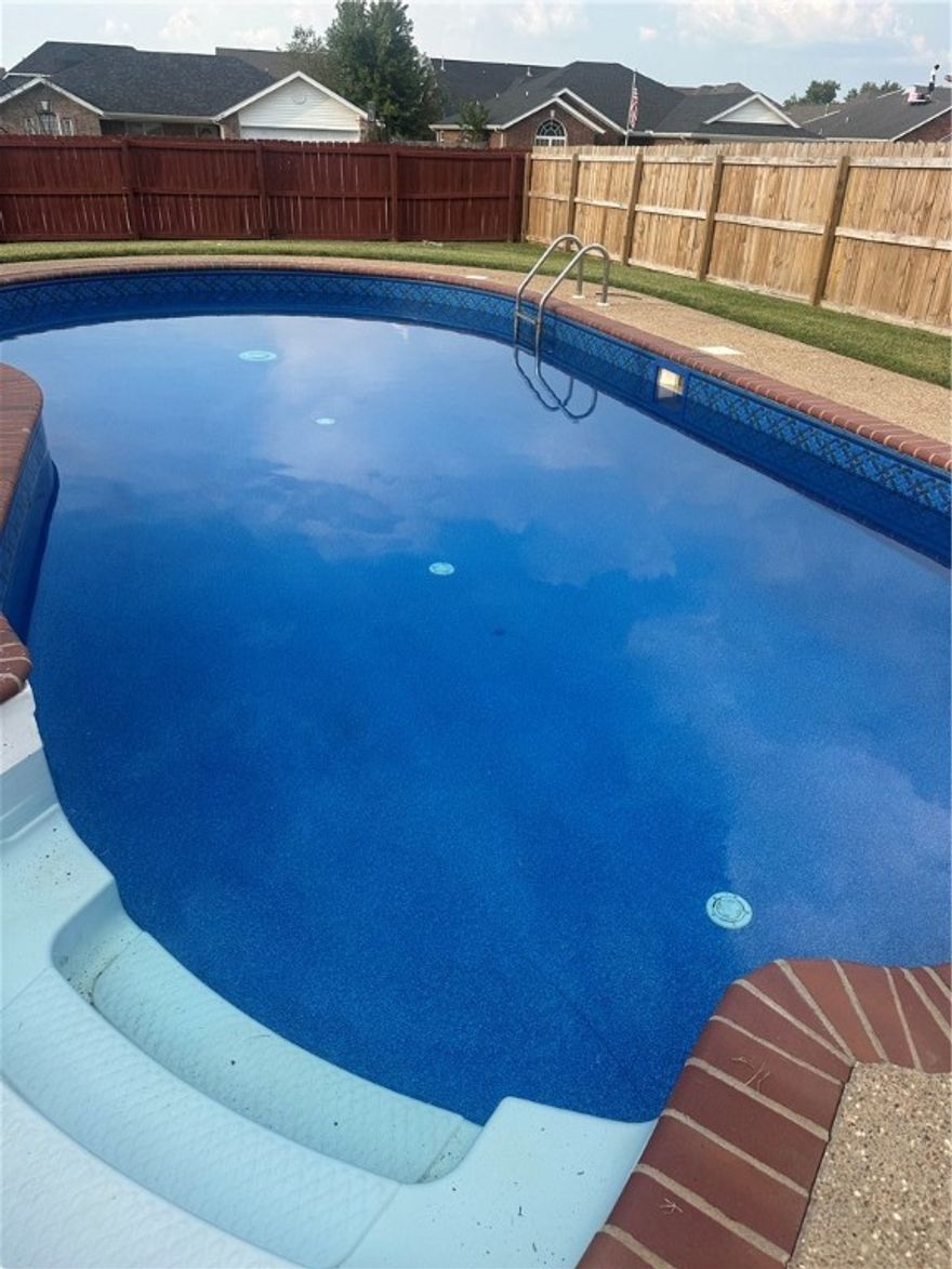 Pool home in Bentonville - under $415,000.  This is it!  Situated on an oversized (.30 acre) corner lot in Bentonville's desirable Windwood subdivision, this updated 3 bedroom, 2 bath home offers 1845 sq ft of living space with an open feel from kitchen, dining, and living room.  Built in 2003 and thoughtfully updated, this home features an eat in kitchen, formal dining room, and a side entry garage!  You can have your very own staycation paradise, with a newly lined in-ground swimming pool - perfect for entertaining and lots of fun.  Recent upgrades include new pool liner (2025), new HVAC system (2022), new garbage disposal (2023), smart thermostat, rain shower in the primary bath, updated showers in both baths.  Located just minutes from local schools, parks, and shopping, this home blends comfort, convenience and outdoor enjoyment.  Just a short drive to the new Walmart Headquarters campus.