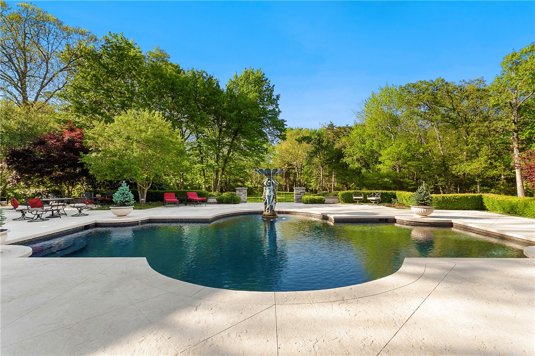 Distinguished gated estate on 3.28 acres positioned on Fayettevilleās east side. Welcoming circle drive, exquisite fountains & sprawling lush grounds offer a resort style pool, hot tub, outdoor kitchen & fireside patio providing a backdrop of serenity for the entertaining enthusiast. This 5 BR, 5.5 bath property will not disappoint. Sophisticated guest house w/living & kitchen, laundry, 2 baths & private BR suite w/balcony & picturesque views. Appreciation for architectural elements & high-end finishes are unsurpassed. Elegant foyer w/designer staircase features custom marble throughout, walk-in wine room, gentlemenās library & formal dining. Gourmet kitchen w//upgraded Wolf appliances opens to breakfast & living areas encompassing a wall of windows. Exquisite owner suite w/sliding glass doors to embrace the outdoors. Gorgeous marble bath w/detailed finishes. Second level ownerās en-suite plus 2 additional guest suites, media room w/wet bar & impressive play/game/bonus room. Enjoy all this estate has to offer.