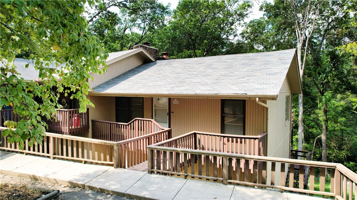 Discover the charm of Bella Vista living in this inviting townhome with a new roof (2023) and a new dishwasher (2024). Nestled in a peaceful setting, this home offers both comfort and convenience along with having two decks for relaxing outdoors while viewing wildlife and enjoying the creek below. Enjoy being moments away from world-class mountain biking trails (such as Tunnel Vision), golf courses (like the premier Bella Vista Country Club Golf Course), nearby recreation center and local shops and businesses. Inside you will find a functional layout with 2 bedrooms with beautiful natural wood ceilings and 1.5 baths. Welcome to your retreat! Storage space below townhome. Refrigerator conveys.