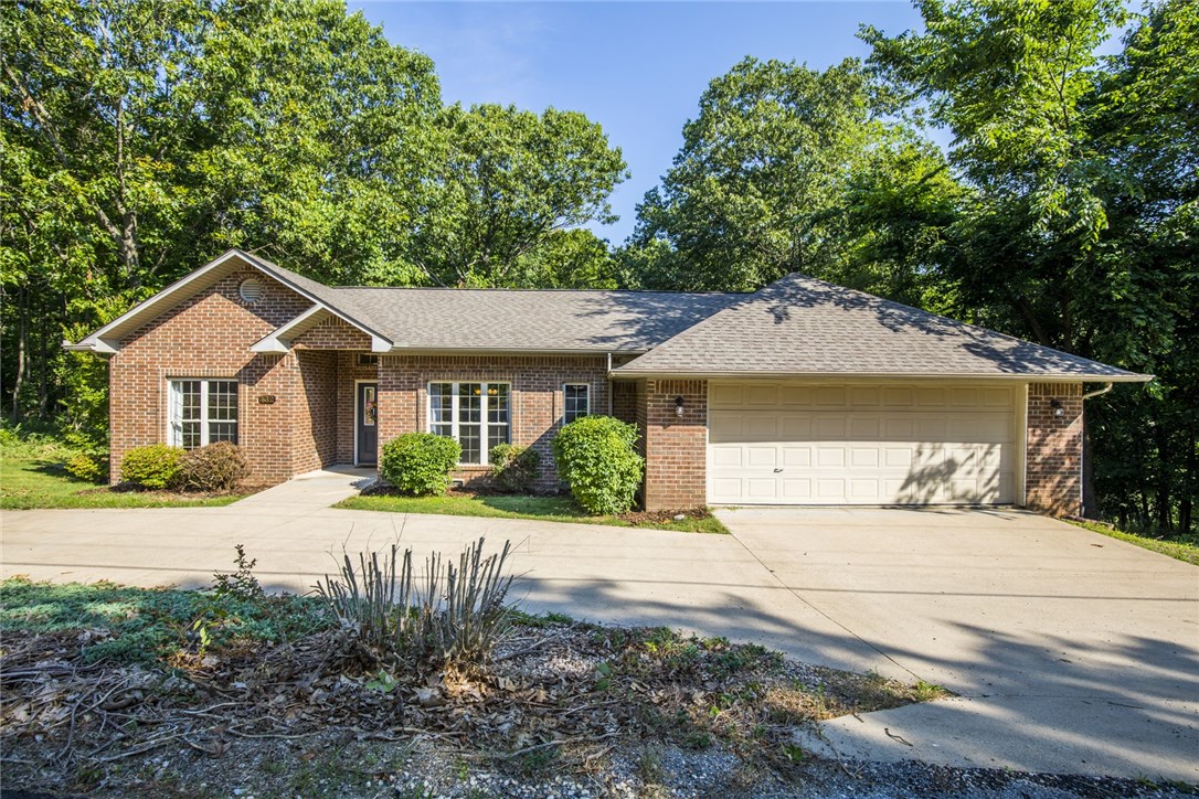 Beautiful home MOVE IN READY! Tons of windows for natural light. Formal Dining, Kitchen with stainless appliances, 200 Sq ft sun room with a view, master bath has a new tiled shower, large utility room with extra storage and tall ceilings with intricate cross beams make this home nice and airy. There is a 463 Sq Ft shop under the home with extra storage. The Sun Room and Back Deck give you a great view of the wildlife.