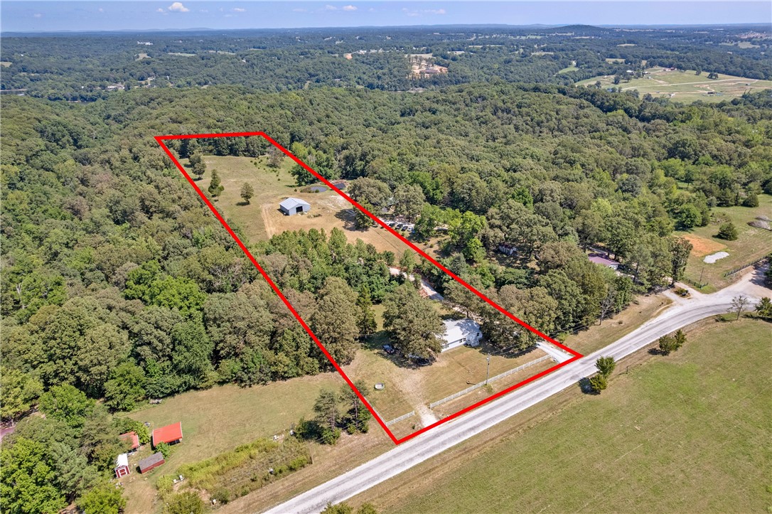 Invest in land with immediate and future value just 1 mile from a boat ramp on beautiful Beaver Lake and within the sought-after Vandergriff School district. This +/- 5-acre tract includes a spacious 40×40 barn, installed driveway, completed perc test, and approved water tap with line already in place, helping you save time and cost in development. Surrounded by expanding residential areas and close to city conveniences, this property offers an excellent opportunity for a new build or long-term hold. Sale is subject to final lot split approval.