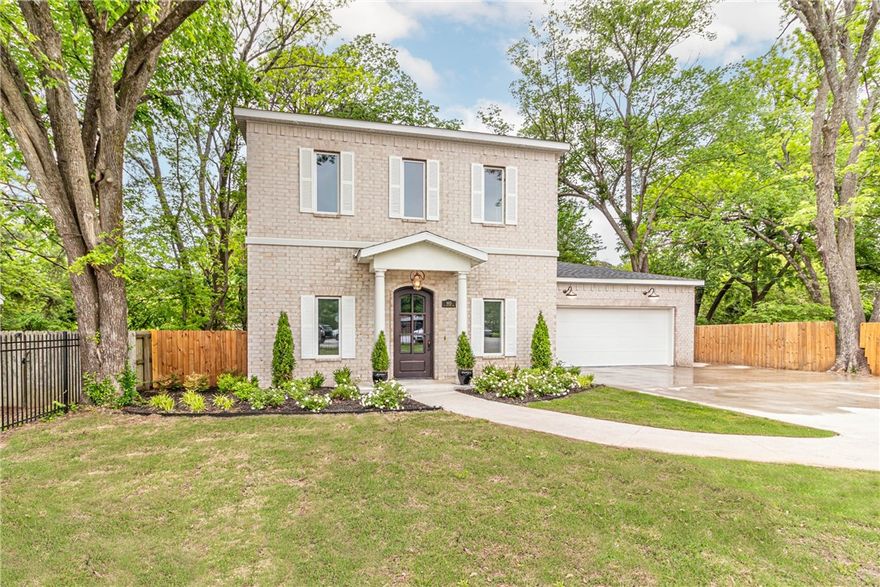 Beautifully custom-built 2,561 SF home less than a block from the Razorback Greenway and under a mile to the University of Arkansas. Located on the U of A bus route, this thoughtfully designed home offers a main-level primary suite, gourmet kitchen with granite counters, Bosch dishwasher, and Jenn-Air range, open living with a gas fireplace and granite surround, and exceeds Energy standards by 20%. Custom finishes throughout include a striking steel front door, custom steel stair railing, designer lighting, premium plumbing fixtures and tankless hot water heater. Upstairs features 3 spacious bedrooms and two full baths. Enjoy a large, wood privacy-fenced backyard perfect for entertaining. Walk, bike, or bus to campus and explore Fayetteville’s best parks, trails, and amenities. A rare find that blends luxury, comfort, and unbeatable location—schedule your showing today! Range vent hood is being installed. Refrigerator, washer and dryer convey.