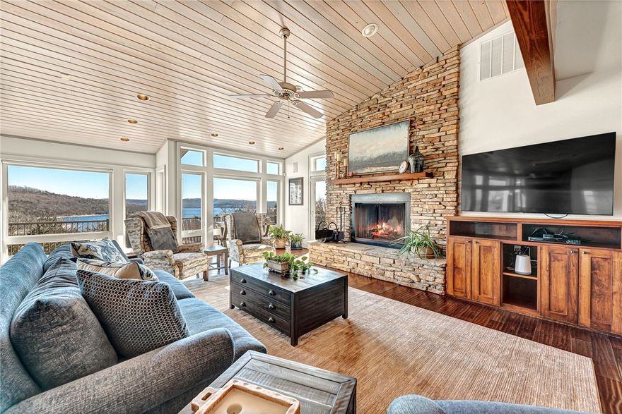 Welcome to your lake home oasis with million dollar views, boat slip, and private elevator. As you enter you will find floor to ceiling windows for enjoying the expansive lake views. The main floor features an open concept great room with stunning stacked fireplace that overflows onto the deck and screened in porch, perfectly designed for relaxation and entertaining. Two large primary bedrooms with ensuites. The second story library/den also has water views. Amble built in shelving and storage areas throughout home. On the lower level you will find two bedrooms, garage, a bonus room and a large full bath that doubles as a safe room. This architecturally designed, custom built and professionally decorated home has all you need and more.