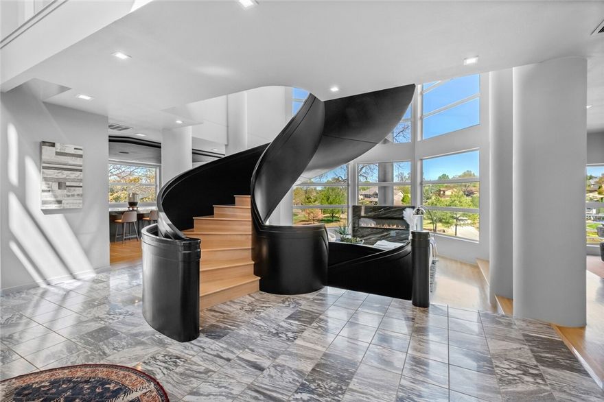 Modern Luxury in Exclusive Pinnacle-Experience refined living in this minimalist architectural gem overlooking Hole 5 of the golf course. This unique residence boasts soaring ceilings, 4–5 bedrooms (including 3 private en-suites), and a show-stopping spiral staircase. The professional-grade kitchen features sleek lines, an endless waterfall island, and top-tier appliances. Entertain effortlessly with three spacious living areas, a formal dining/wine/bourbon room, butler’s pantry, wet bar, & flexible office space. Enjoy serene evenings inside or out with panoramic views of the rolling greens. Additional highlights include a heated/cooled 3-car garage with storage room & a secondary laundry/pet wash station. Over $600K in recent updates. Bentonville School District.