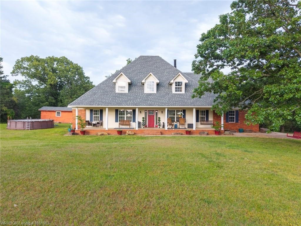 A stunning 4-bedroom, 2-bathroom home with a home office sitting on 5.8 level pretty acres just minutes from town. The property offers 2,766 square feet of living space and features a recently updated kitchen with stainless steel appliances, including a gas range and quartz countertops. The pantry doubles as a storm shelter and the kitchen has a breakfast bar and an eat-in area large enough for a table & 8 chairs. The open kitchen-living concept is enhanced by ample recessed lighting and built-ins. Updated lighting fixtures are present throughout the home. The spacious master bedroom includes a luxurious, updated spa-like bathroom with a tiled walk in shower with a bench, a freestanding tub and a walk-in closet. The massive upstairs bonus room serves as a fourth bedroom with a long closet or could be a 2nd living area/flex room. The walk-out attic provides excellent storage. The home also boasts a large covered front porch with a swing, ideal for enjoying morning coffee.