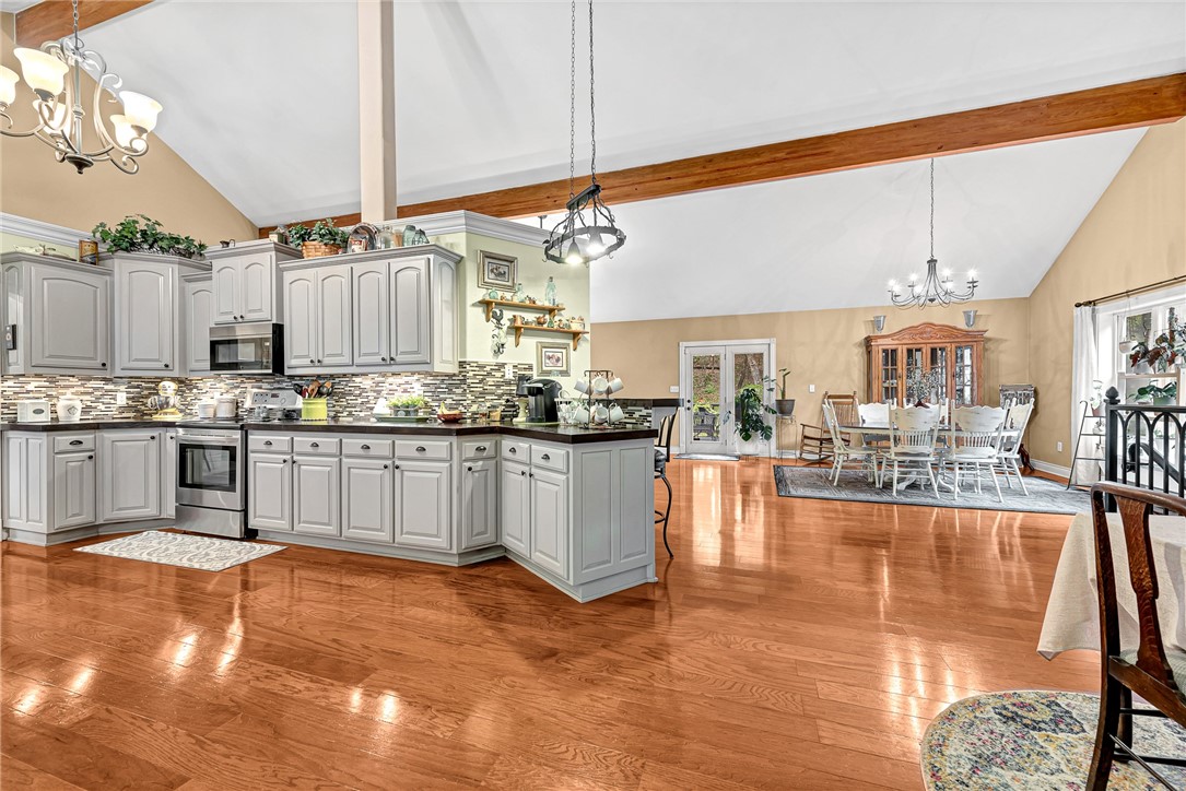 This stunning multi-level home is nestled at the end of a quiet street, down a long, paved driveway, and sitting on 1.43 acres in the heart of Berryville. On the main floor, you will find 3 bedrooms and 2 full baths, an open concept living, dining, and kitchen surrounded by large windows that let in abundant natural light, cathedral ceilings, beautiful wood floors, crown molding, wood accents, and many custom finishes. The kitchen boasts of custom cabinetry, concrete countertops, tiled backsplash and stainless appliances. Downstairs, you will find a large flex space, 3 bedrooms, 2 full baths, large laundry room, storm shelter, and tons of storage. Above the garage, find more storage and a large workspace. This home was built with energy efficiency in mind using Structural Insulated Panel construction, R40 upstairs, and R50 downstairs, creating lowered utility costs. You can breathe easy with the whole house fresh air exchange system. This is a one-of-a-kind gem; you would be proud to call it home.