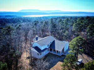 Stunning West Russellville home with 6.59 acres! This modern beauty is a masterpiece with its incredible architecture that offers large windows and outdoor views from every room. Inside the 2931 sf home you'll enjoy a large open living room with a cozy fireplace. The master on the main level offers a jacuzzi tub, walk in shower, and two abundant closets with a laundry room inside! The gourmet kitchen offers a commercial grade stove and thermadoor refrigerator not to mention storage everywhere! The formal dining area is private and perfect for entertaining! Upstairs you will find a landing that is ideal for an office or sitting area and two spacious bedrooms! The garage is every hobbiest's dream and even has its own private office! Two big beautiful decks let you take in the view!
