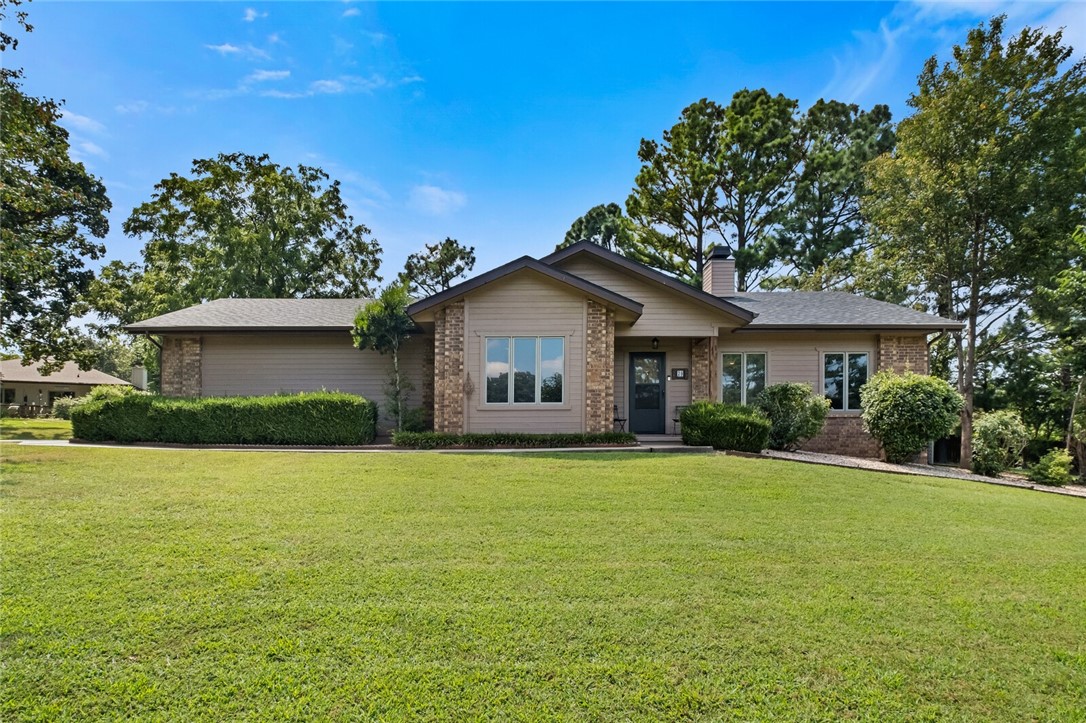 Super rare half acre flat lot in Bella Vista located less than 3 minutes to Lake Lomond marina, several restaurants, dog park and Branchwood Rec Center. Back40 Trail is a minute bike ride with several other trials surrounding this home. Home was fully remodeled in 2022 / 2023 with new real hardwood floors, fresh paint (interior and exterior), new granite, new hardware, new lighting, new appliances (all convey), new HVAC (23), new roof / gutters (22), so this home is virtually brand new! When you open the front door you will see the new real wood floors throughout entire home! The great room has a central fireplace with built-ins on each side and a dining area in the back. The kitchen is off the great room with new granite, freshly painted cabinets and all new stainless black appliances. Primary bedroom in back of home with ensuite featuring a full size walk-in shower and big walk-in-closet. Two more bedrooms and a bathroom at front of home allow for privacy. Relax under the covered porch in flat, fenced backyard.