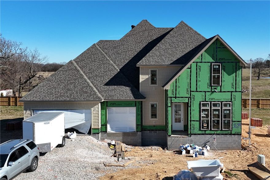 Welcome to County Line Square, a new Springdale community near Shaw Family Park with a pool and pavilion for residents. This home opens into the main living area, creating an inviting first impression. The living space features a fireplace and 3 large windows. From here, the layout flows into the dining area and kitchen, with French doors leading to the covered back patio. The kitchen includes a large island, quartz countertops, and cabinets to the ceiling. Engineered hardwood floors run throughout the first floor. A bedroom sits toward the back of the home with a full bathroom nearby. The primary suite features a vaulted ceiling, a bathroom with a double vanity and centered makeup vanity, a walk-in shower, and a walk-in closet that connects to the laundry room. A mudroom and 3-car garage are also located on the main level. Upstairs offers 3 bedrooms and a full bathroom. A fence, blinds, and gutters are included. Builder’s preferred lender is offering $3500 toward closing costs or a rate buy down. *Agent Owned*