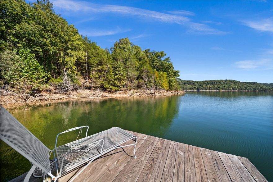 Here is a remarkable lakefront property on Beaver Lake at the end of Angell Rd.  Two parcels of land over 15 acres with a 1400SQFT cabin and a private 2-slip boat dock with two- 10 x 25 slips and a swim platform.  Pretty trees all around and quiet Hogscald hollow for your retirement or vacation dreams.