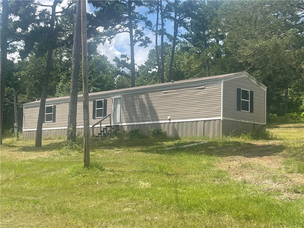 MOVE IN READY! This is a new manufactured home--only a few years old. Absolutely gorgeous and in meticulous condition. 3 bedroom 2 bath with a split floor plan. Very well designed. Cute kitchen with plenty of cabinet space. Quiet, "end of the road" location with woods surrounding 3 sides. Semi-secluded and tranquil! Even offers a circle drive!