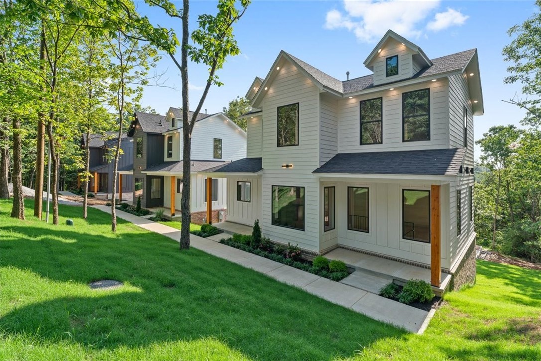 Gorgeous new construction home in the center of Fayetteville close to the University of Arkansas and connected by sidewalks to trail systems. Enjoy four bedrooms each with an ensuite bathroom and tiled walk-in showers. Dual master bedrooms. Luxury features throughout the home including Delta fixtures and Frigidaire Professional appliances. Each floor is independently zoned with dedicated HVAC and insulated floors for sound proofing. Beautiful wood floors installed with premium carpet scheduled for installation soon. Walkout basement includes oversized two car garage and extra large driveway capable of hosting your visitors on game day weekends. Backyard is wooded on three sides with sunset views from WeatherBarr tinted windows. Deer are regular visitors. Two similar homes are also for sale next door.