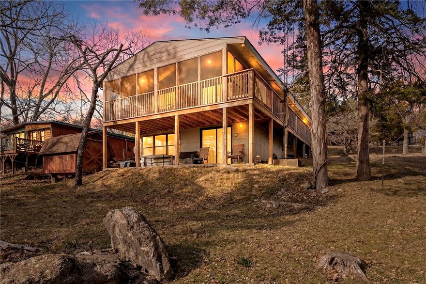 Welcome to 21583 Walnut Street in Garfield, AR, an exceptional opportunity to own a coveted entry-level lakefront home on beautiful Beaver Lake. This fully furnished waterfront retreat offers direct lake access with a boat slip & lift in an 8-slip dock located right behind the home, making lake days effortless & enjoyable. The main level features two bedrooms & 1½ baths, while the fully finished walk-out basement adds valuable living space with a full bath, mudroom entry, & a large room currently used as additional sleeping space. Oversized windows on the lower level showcase gorgeous lake views & fill the space with natural light. Just steps from your door, you can walk easily to your slip & the neighborhood pool/recreation center are only two houses away for added convenience. Furnishings convey, making this a true turnkey property ideal for a weekend getaway, vacation rental, or full-time lake living. Lakefront homes with dock access on Beaver Lake are increasingly rare so don’t miss this must-see opportunity.